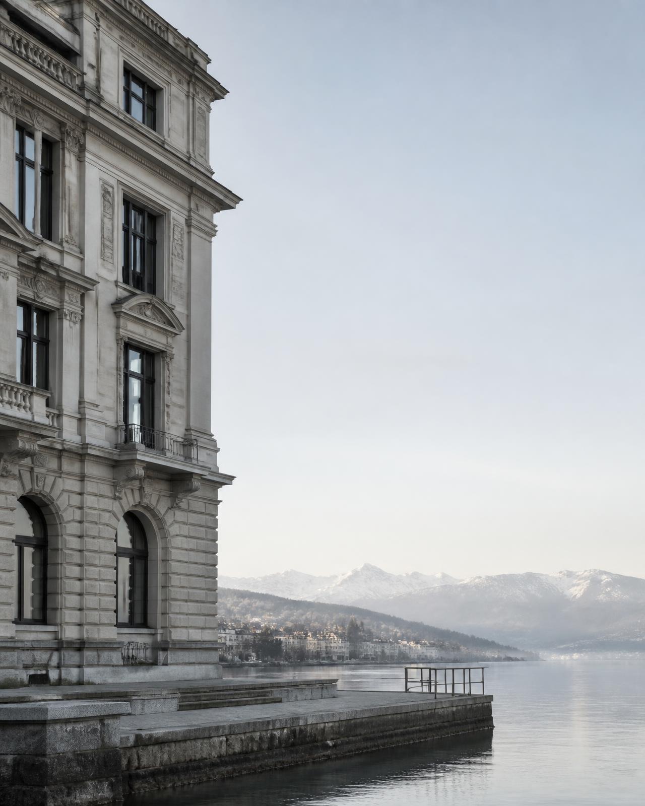 Stone facade beside calm water in cool morning light